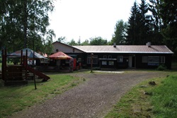 Access road to the camp with a playground and the reception building