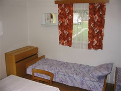Bed with purple bedding in a cabin