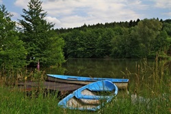 Blue boats on the pond shore