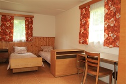 Cabin interior with beds and a writing desk