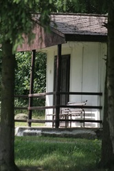 Cabin with a porch among trees