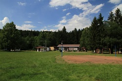 Camp meadow with cabins and a playground