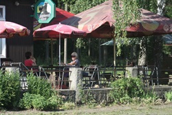 Guests on the restaurant terrace under parasols
