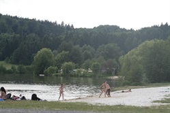 People swimming at the pond beach