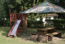 Playground with a slide and a parasol