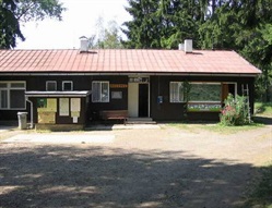 Reception building with a red roof and paved area