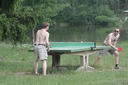 Table tennis on the meadow by the pond