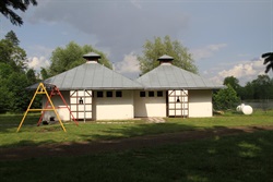 Two service buildings with a children's swing
