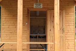 Wooden kitchen with a Kuchyňka / Kitchen sign